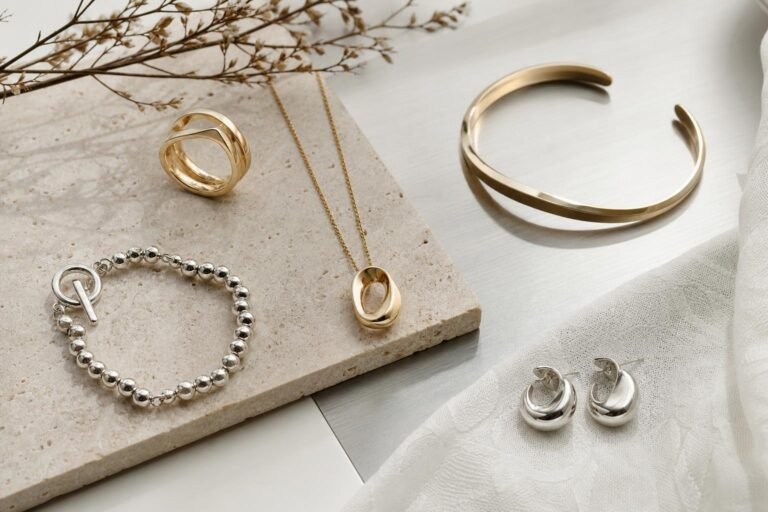 Elegant gold and silver jewelry arranged on a minimalist Seoul-inspired stone display